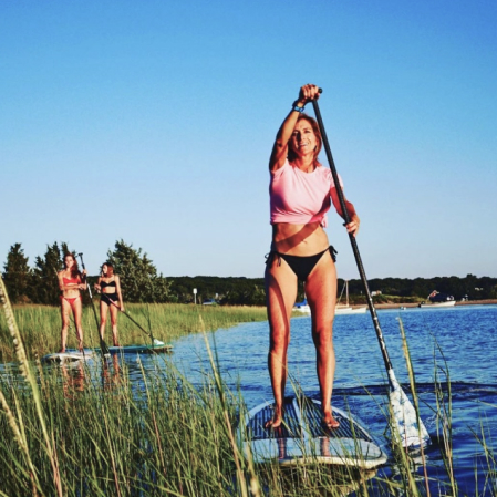 Women paddleboarding on Shelter Island highlights the fun activities at the Rams Head Inn.