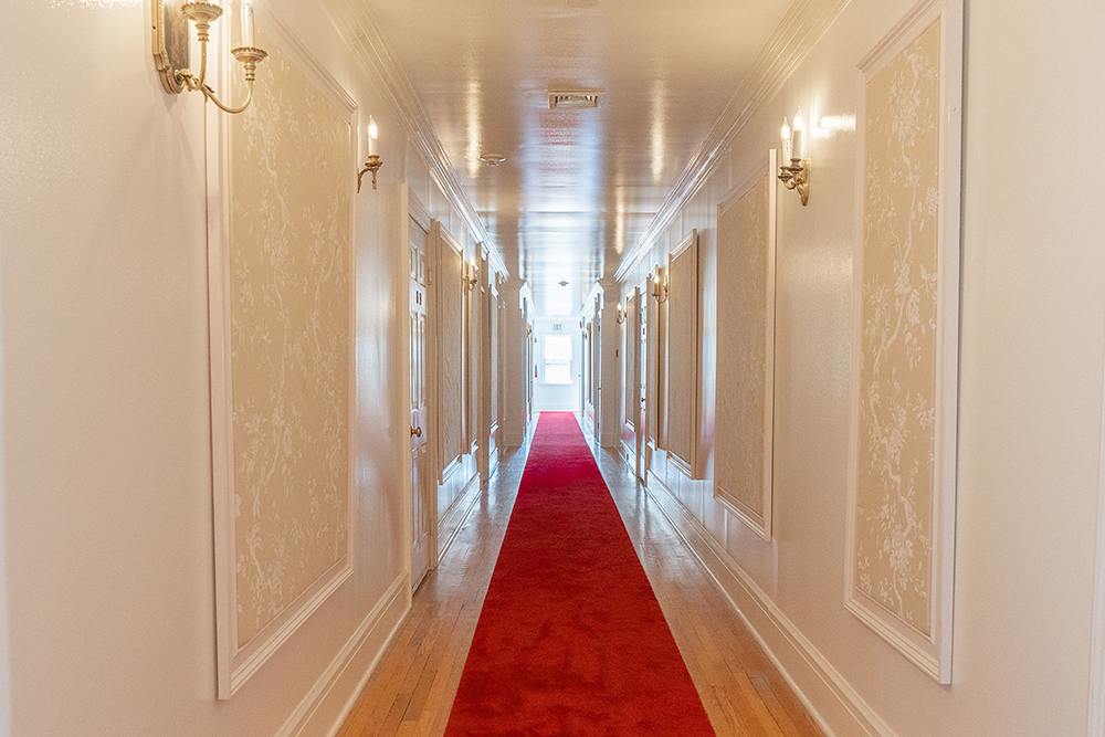 An elegant hallway with a red carpet at the Rams Head Inn on Shelter Island, NY.
