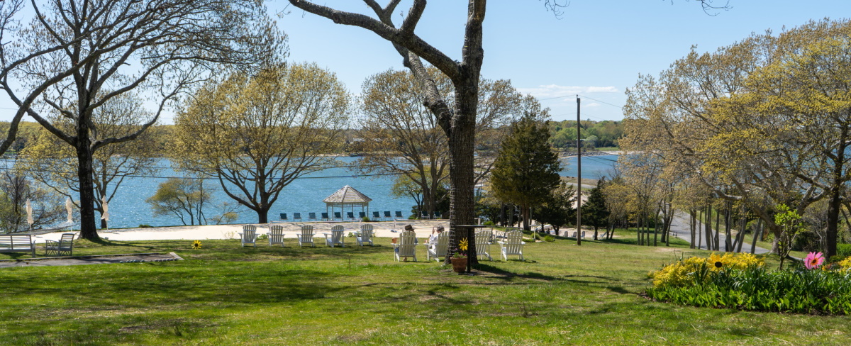 Guests relaxing outside at the Rams Head Inn, soaking in picturesque views on Shelter Island.