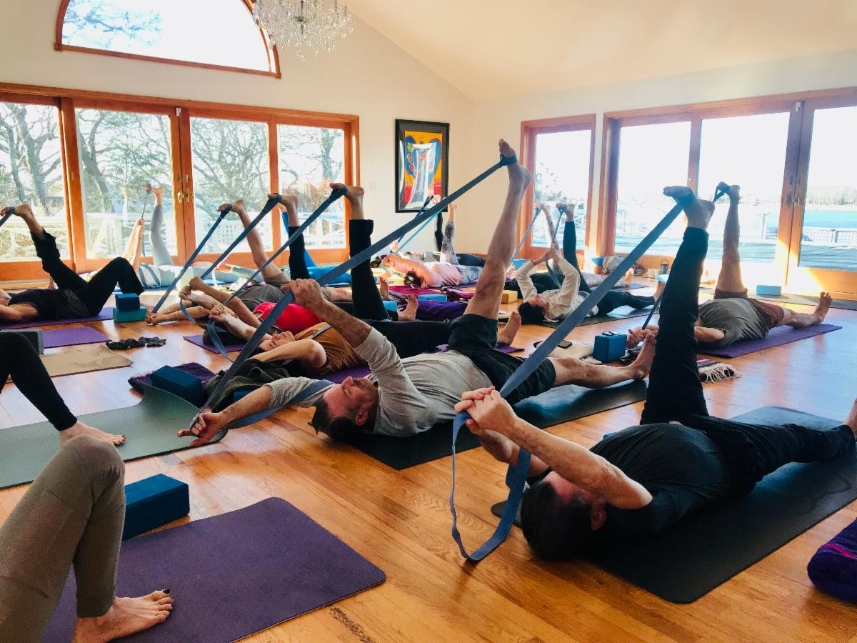 A group of people during a peaceful yoga session at Rams Head Inn on Shelter Island.